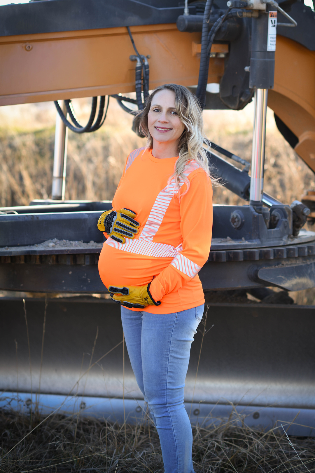 Pregnant worker wearing high visibility HIVIS maternity safety shirt demonstrating proper PPE fit and mobility