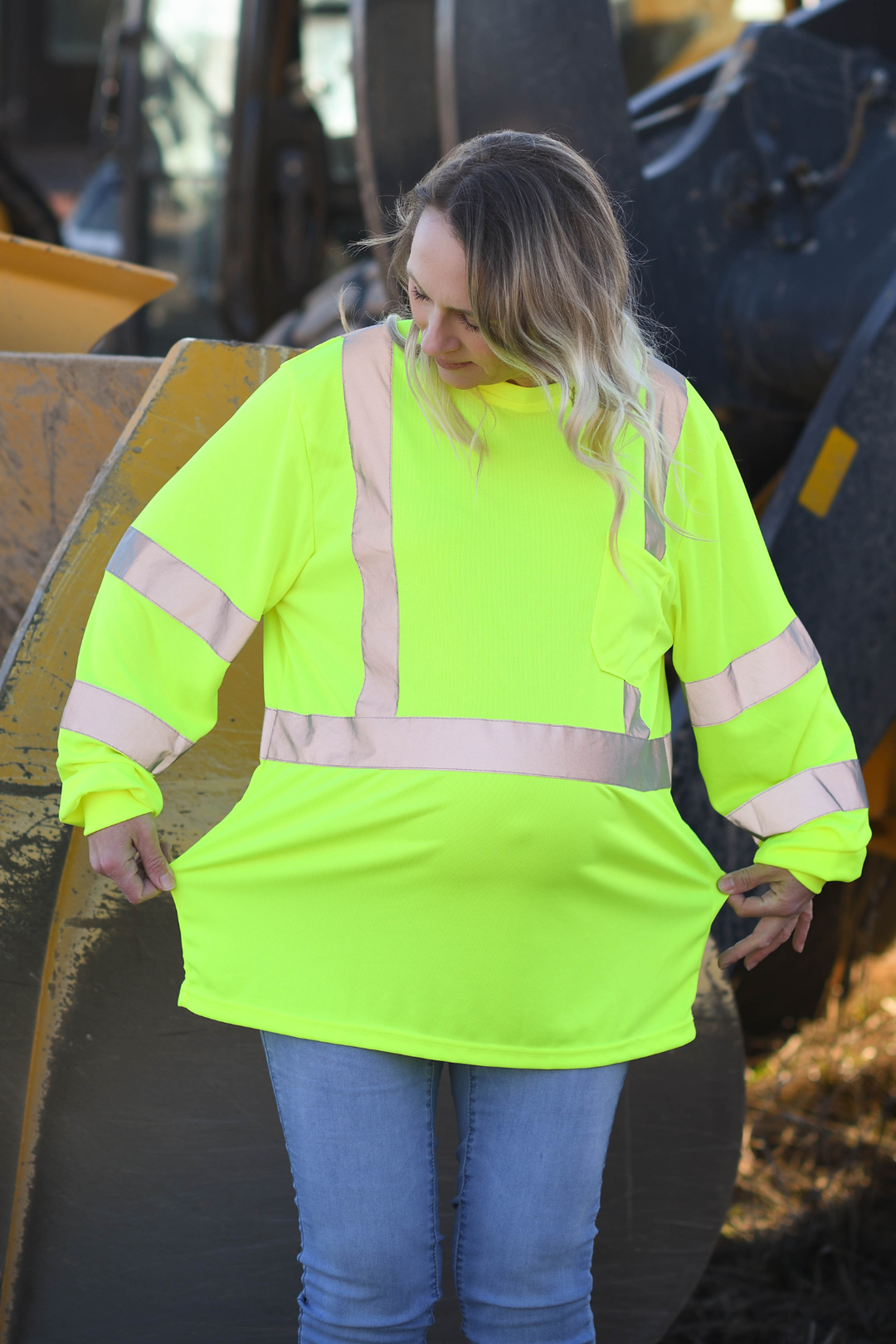 Sized-up standard PPE failing to fit pregnant worker properly, causing excess bulk in some areas and restriction in others